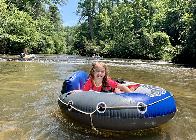 Girl tubes on the Mitchell River in North Carolina